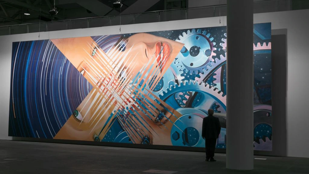 A ceiling-mounted projector casting a large-scale art video onto a gallery wall in a contemporary museum